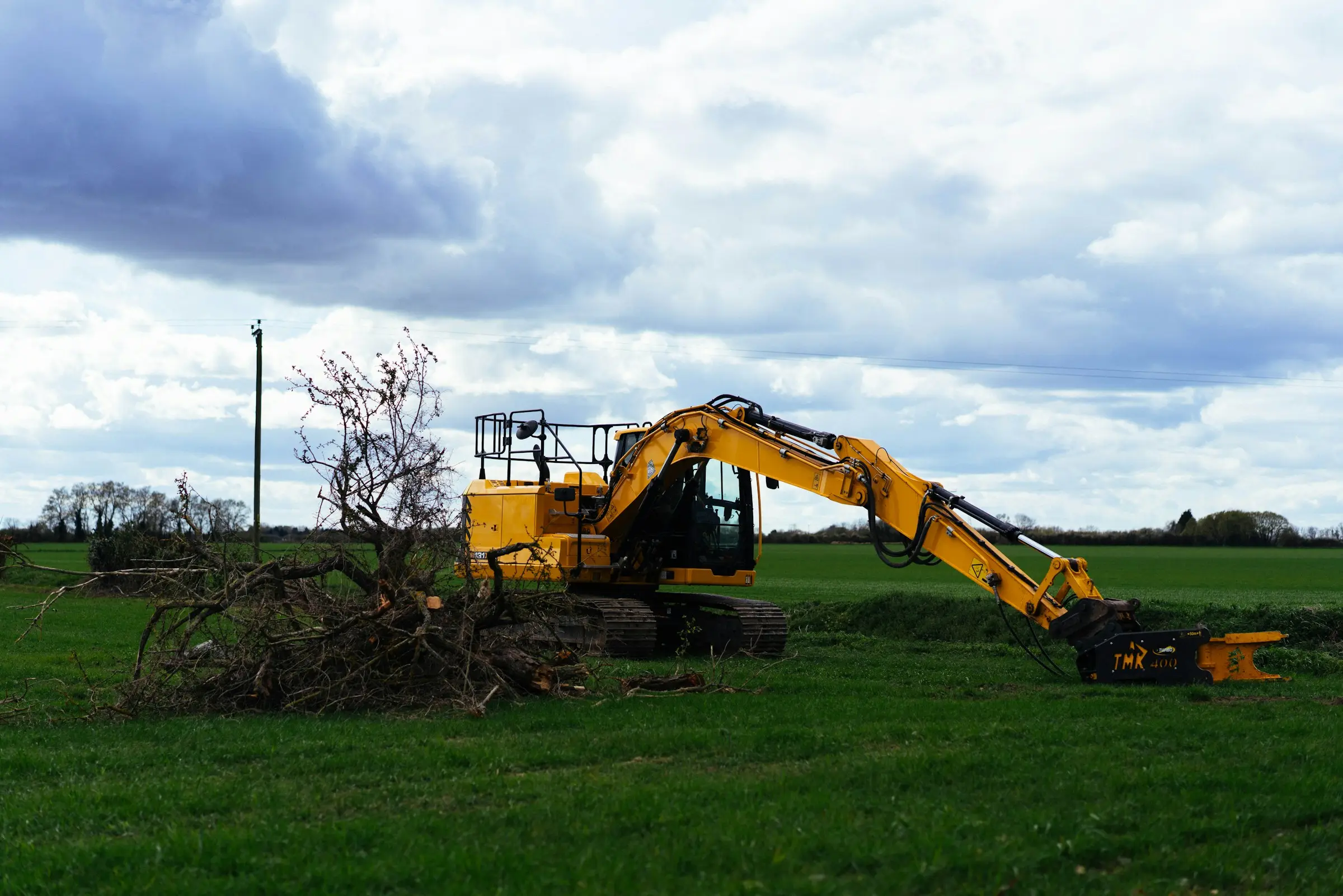 Excavator parked on a cleared site at the end of the day