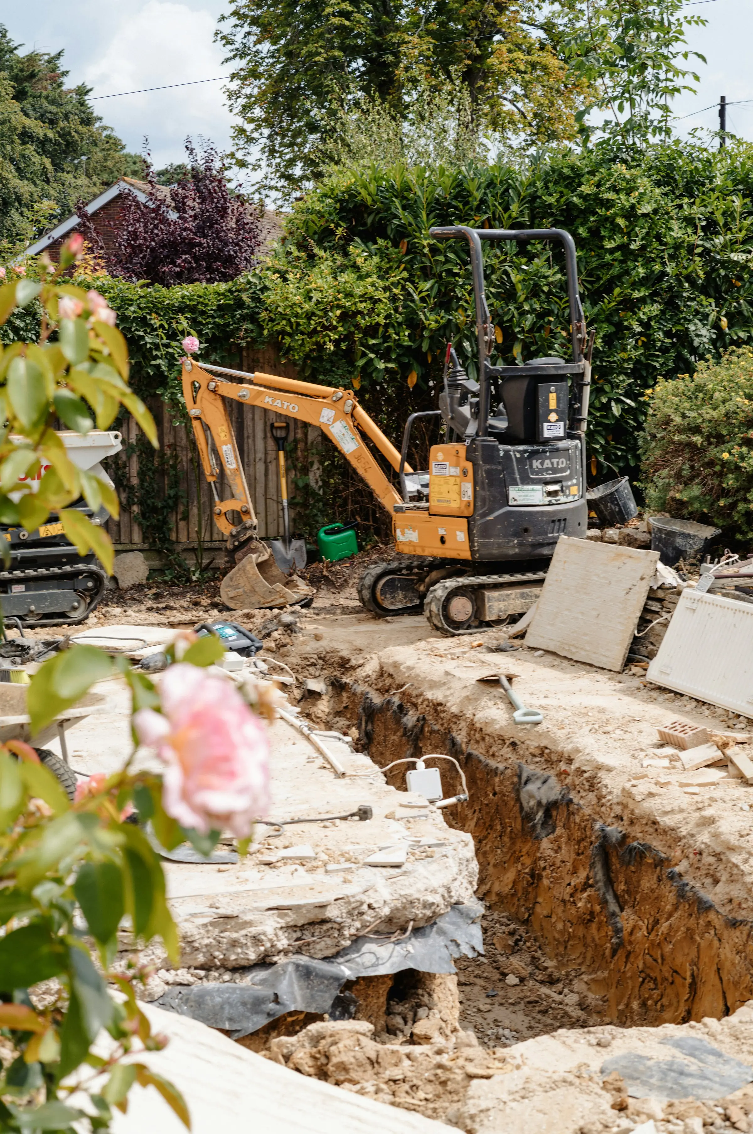 Excavator digging and grading ground on a construction site